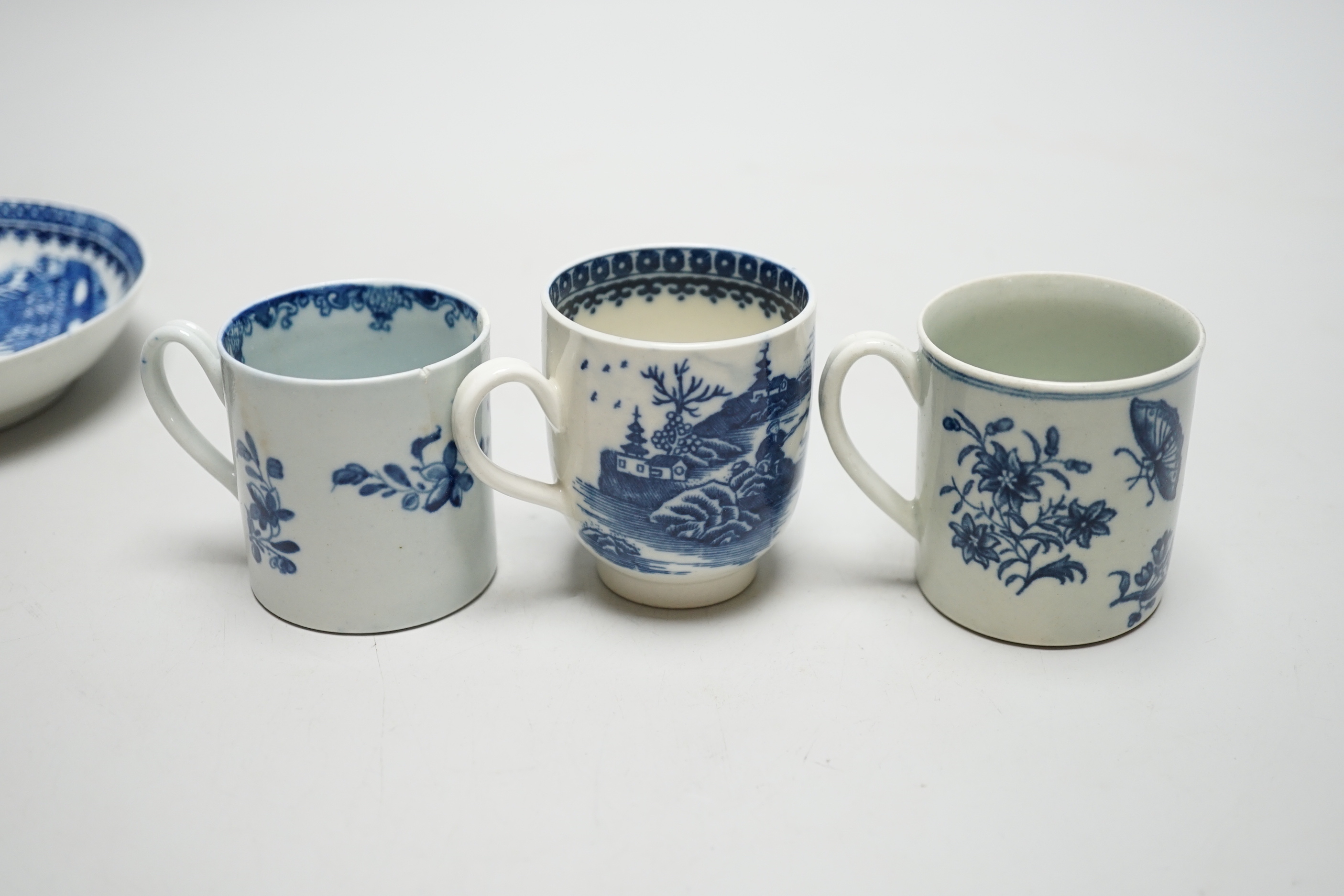 Two Worcester coffee cans, Mansfield and Three Flowers patterns, and a Worcester/Caughley coffee cup and saucer, Fisherman and Cormorant pattern